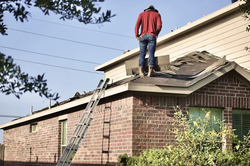 Professional roofer working on a residential roof in New York